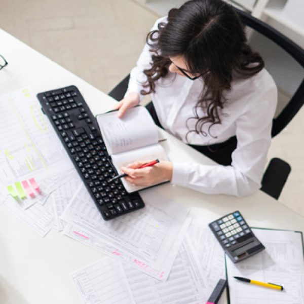 A charming young girl is working in a bright office. photo with depth of field.